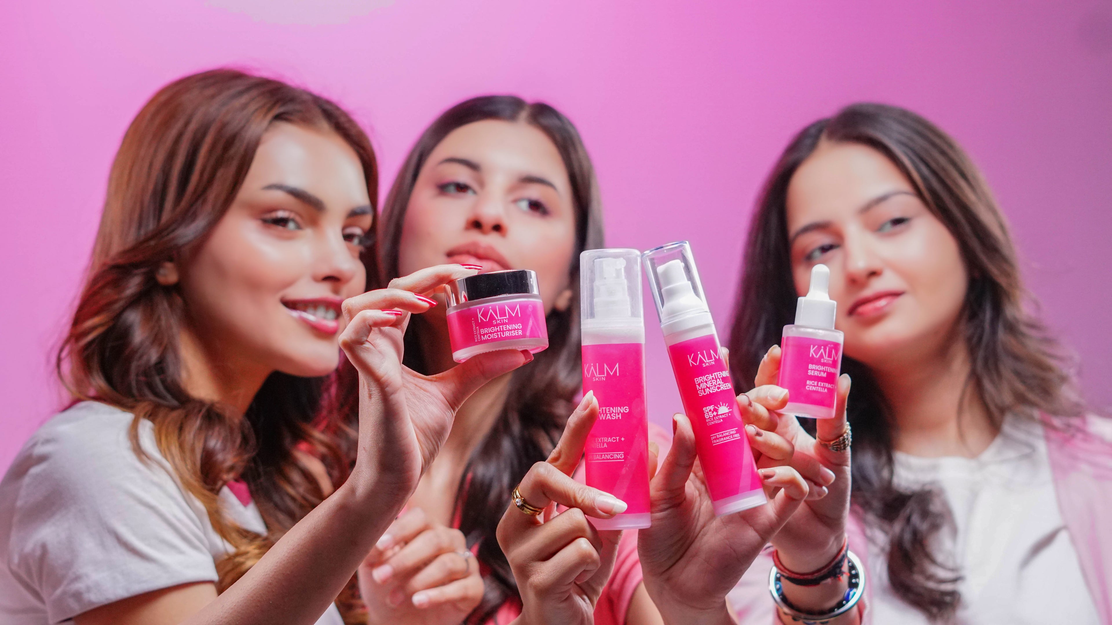 Three women Posing with KALM Skincare Premium Products 