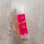 KALM SKIN Rice Brightening Facewash cleanser with rice extract displayed on rice grains with water for gentle brightening skincare