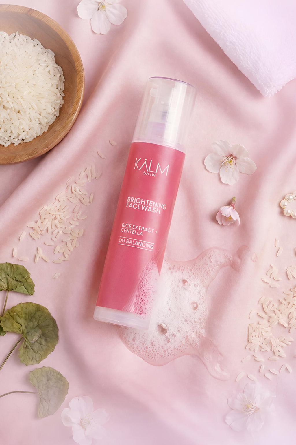 KALM SKIN Rice Brightening Facewash cleanser with rice extract and foam displayed with rice ingredients for glowing skin